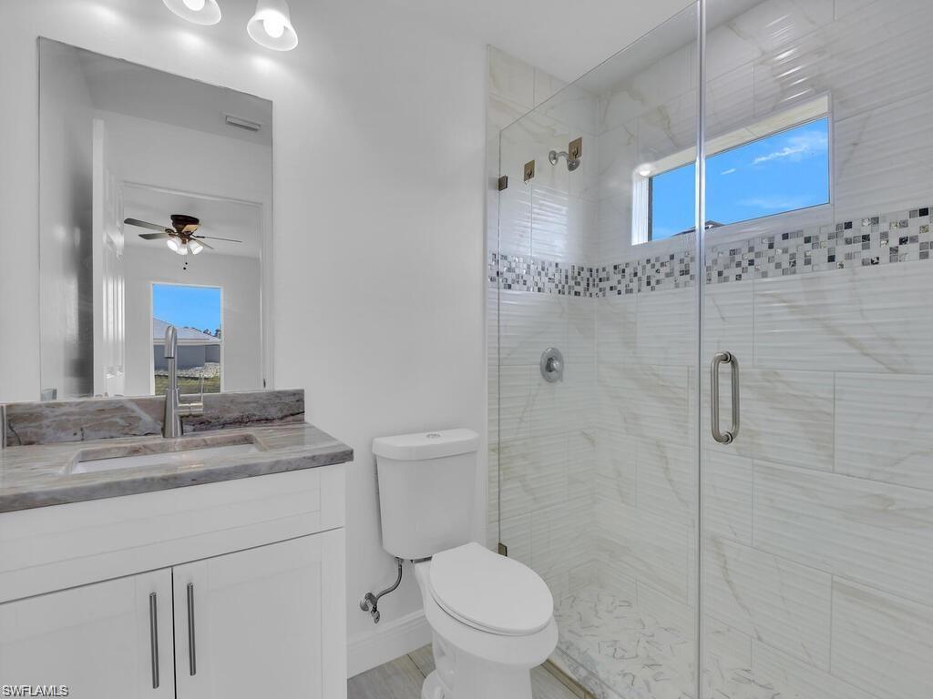 Full bathroom featuring vanity, a stall shower