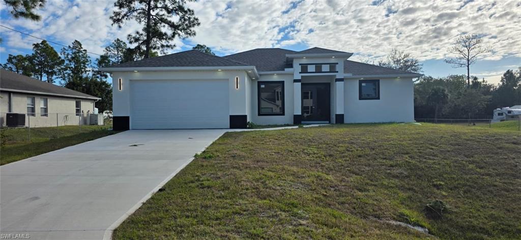 Prairie-style house featuring stucco siding, concrete driveway, and an attached garage