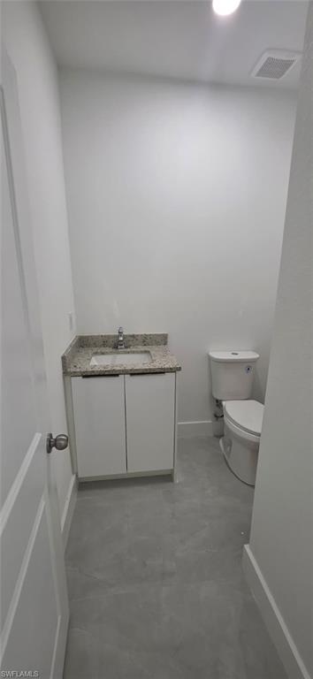 Bathroom featuring vanity and finished concrete flooring