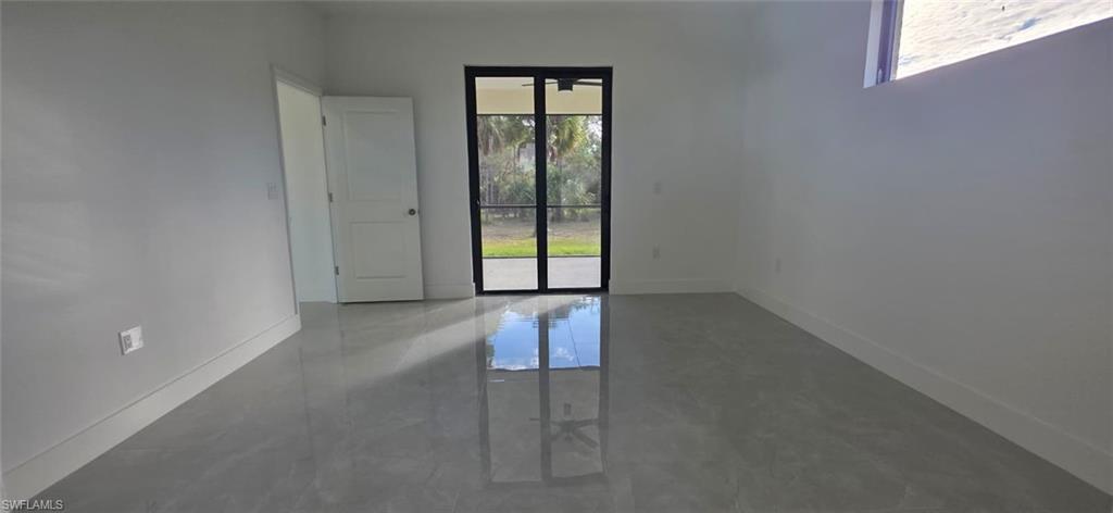 Unfurnished room with baseboards