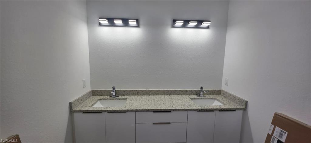 Full bath featuring a marble finish shower and recessed lighting