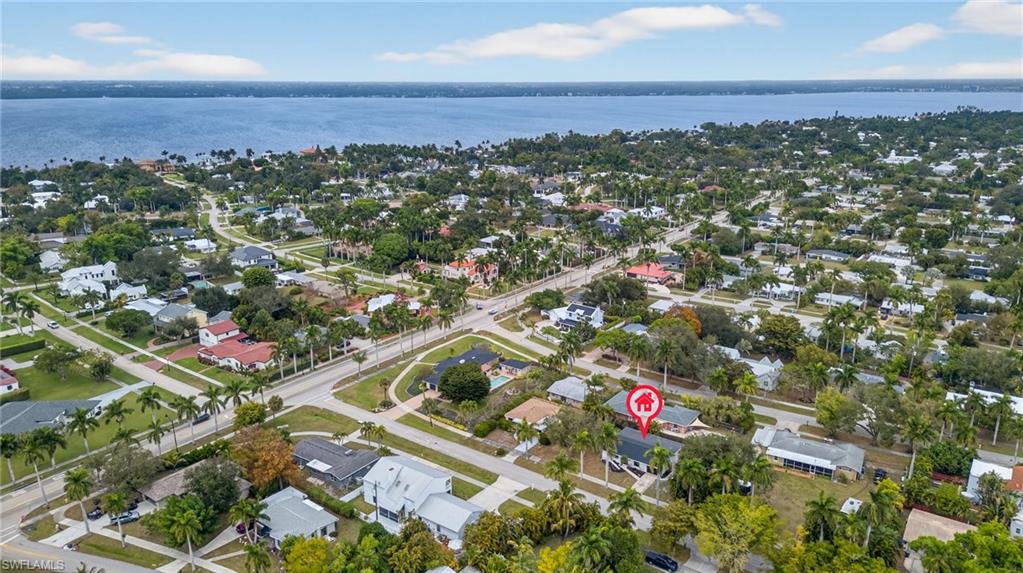 Aerial view of property's location featuring nearby suburban area and a large body of water