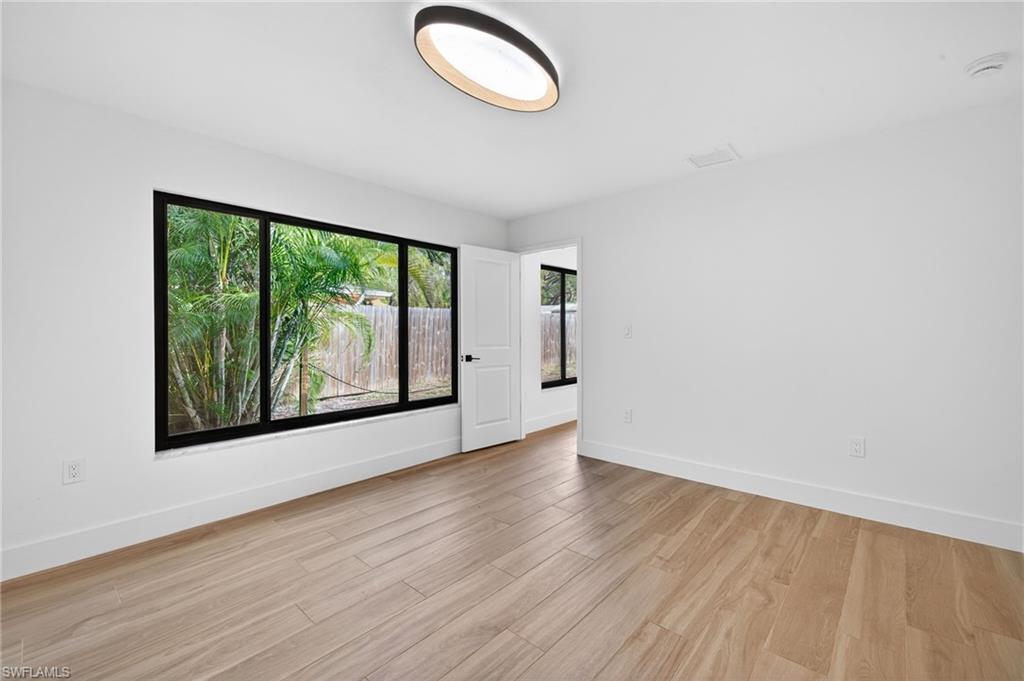 Empty room with baseboards and light wood-style flooring