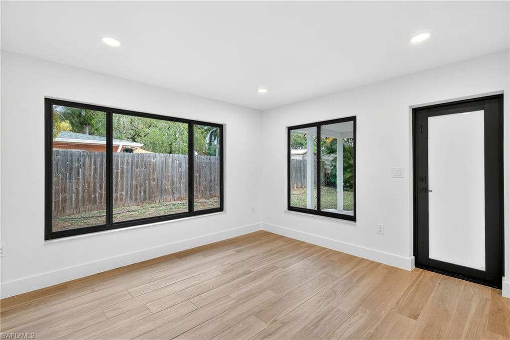 Empty room featuring light wood-style floors and recessed lighting