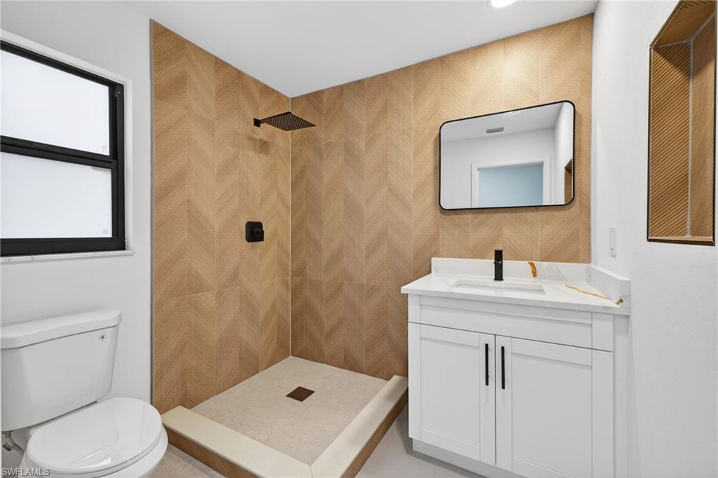 Bathroom with vanity and a tile shower