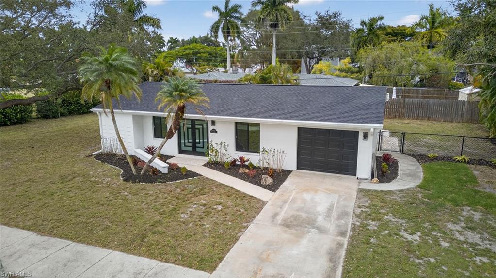 View of front of property with roof with shingles, driveway, an attached garage, and stucco siding