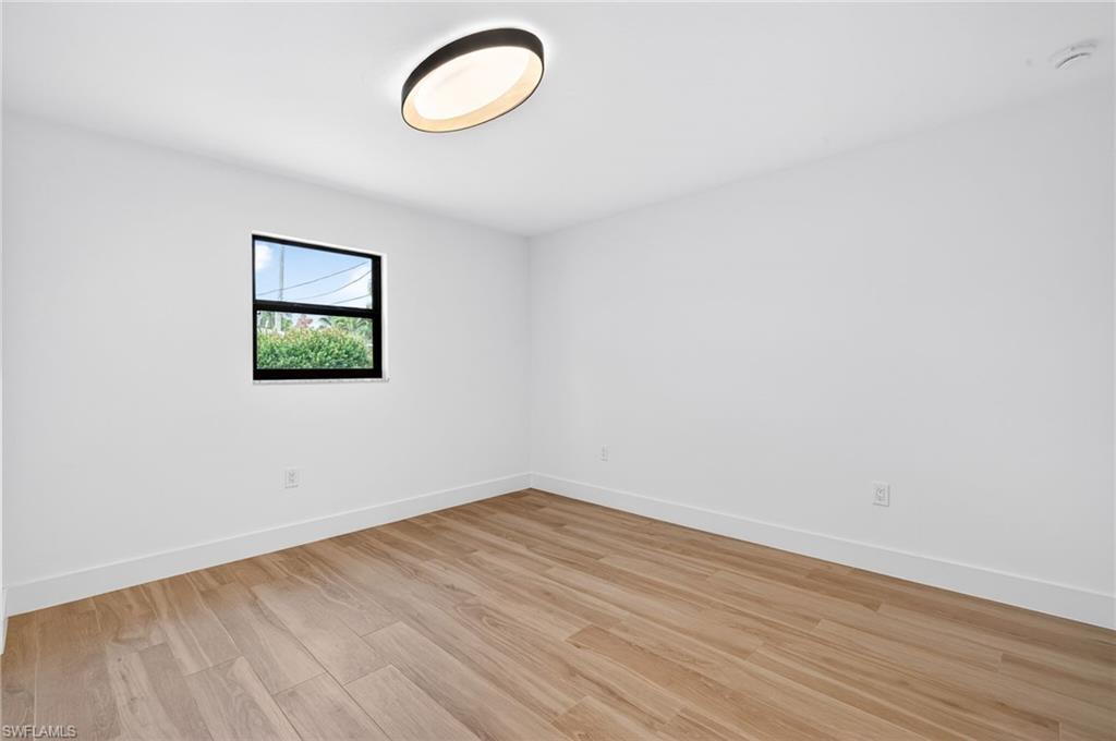 Spare room with light wood finished floors and baseboards