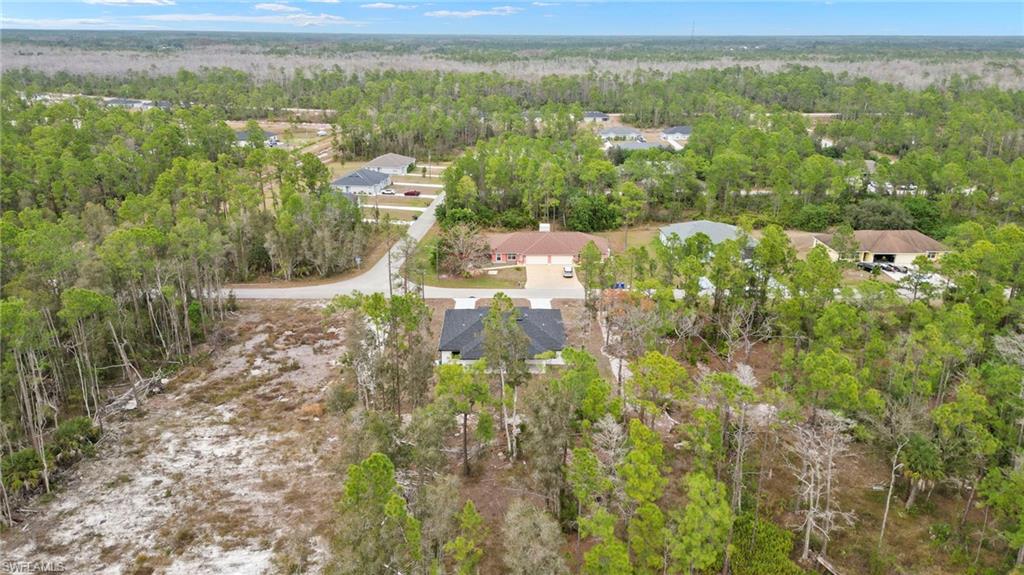 Aerial view of property's location featuring nearby suburban area