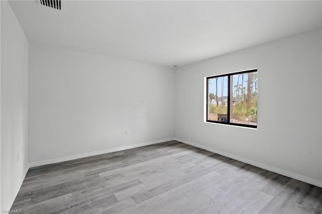 Spare room with light wood-style floors and baseboards