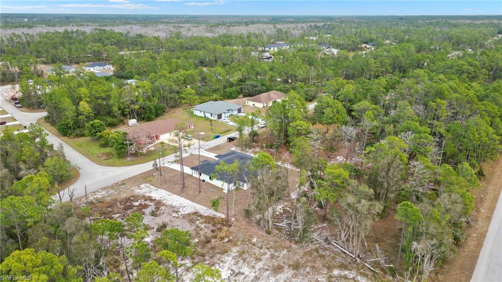 Aerial overview of property's location featuring a heavily wooded area