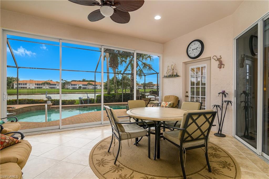 Sunroom / solarium with a patio area, a residential view, ceiling fan, and outdoor dining area