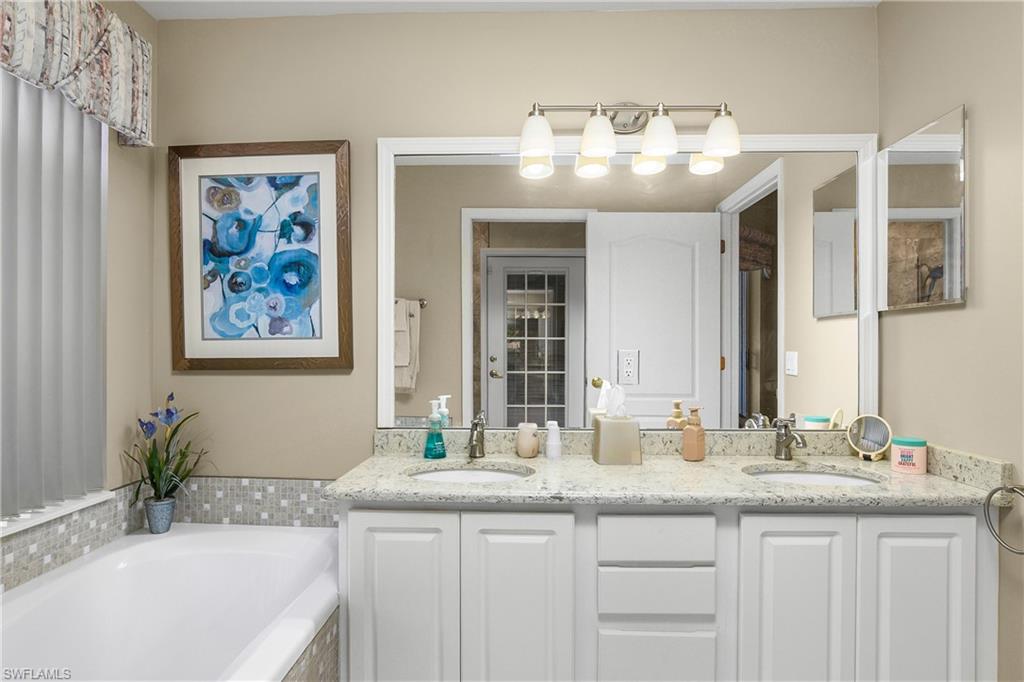 Bathroom with double vanity and a bath
