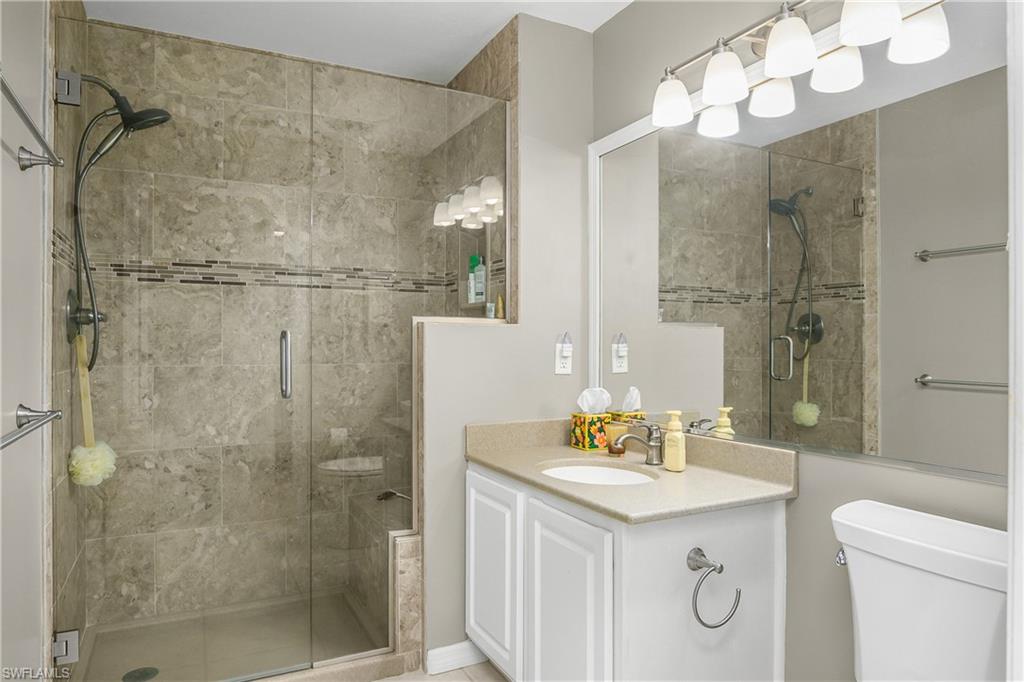 Bathroom with a shower stall and vanity