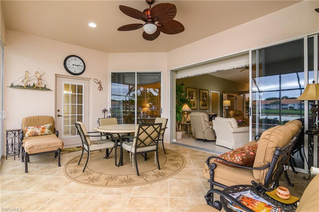 View of patio with outdoor dining area and ceiling fan