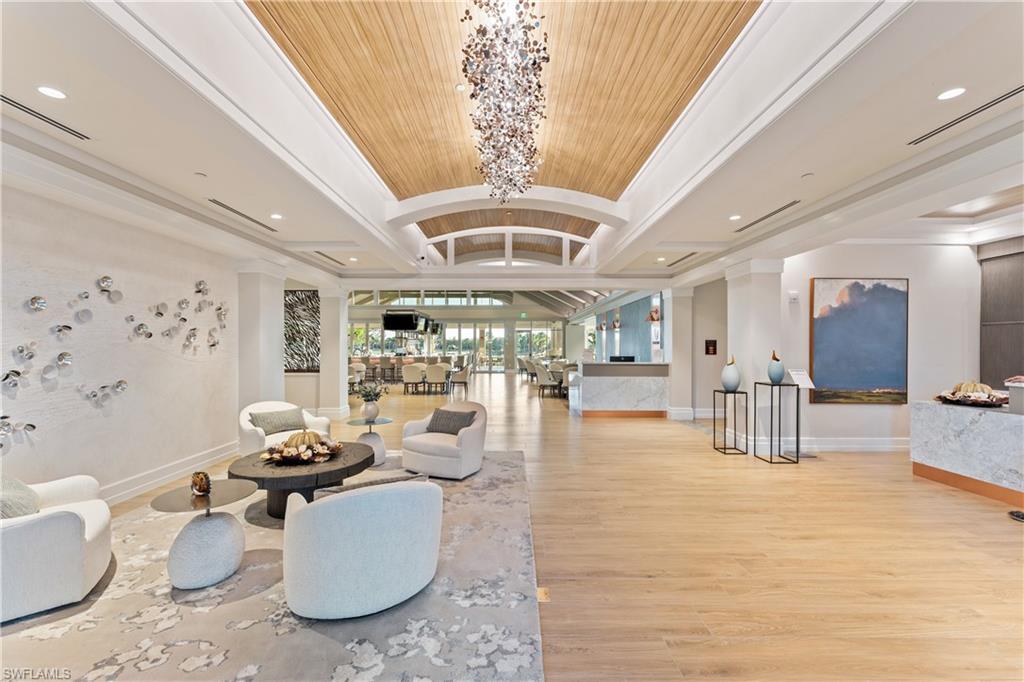Lobby featuring lofted ceiling, ornamental molding, and recessed lighting