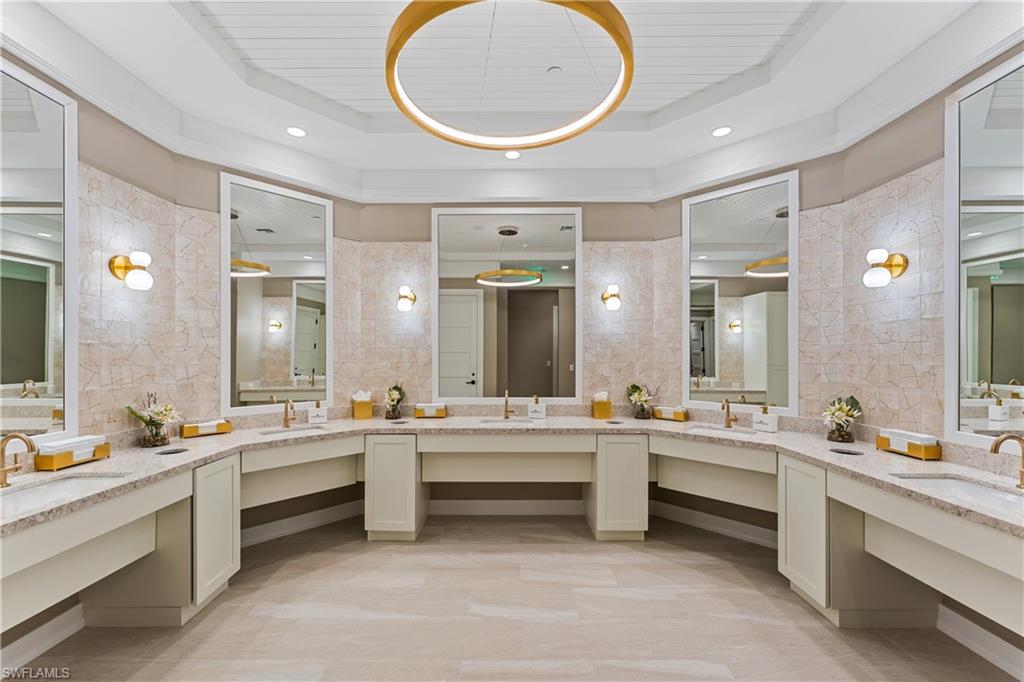 Women's bathroom featuring vanity and recessed lighting