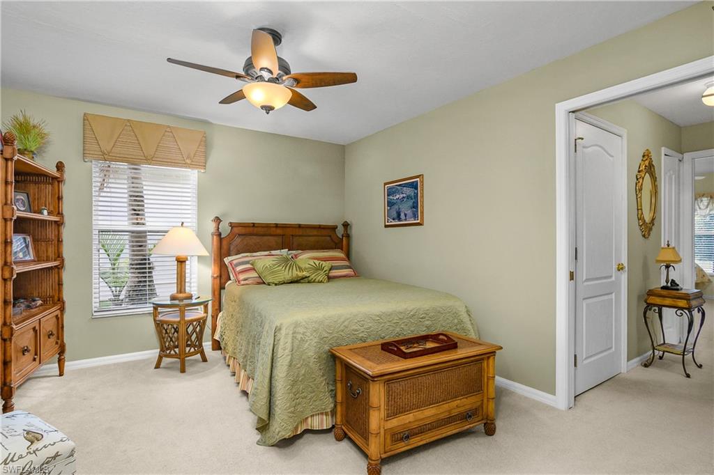 Bedroom with light colored carpet and ceiling fan