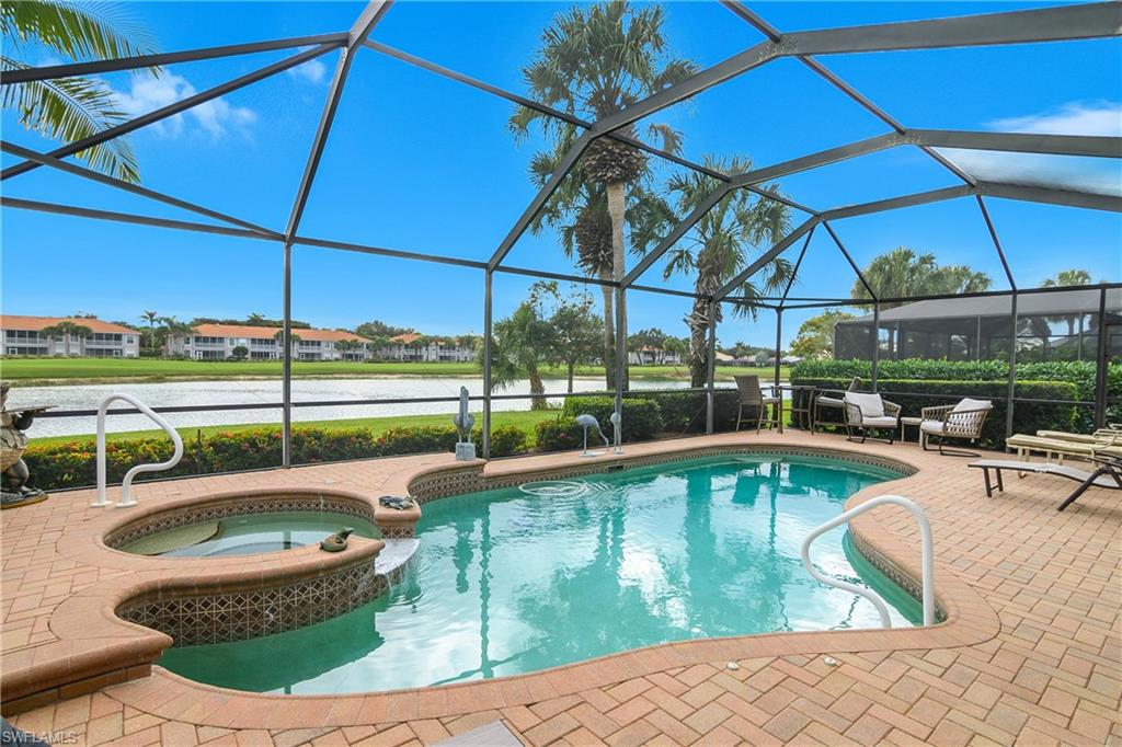 View of swimming pool with a sunroom, glass enclosure, a water view, and a pool with connected hot tub