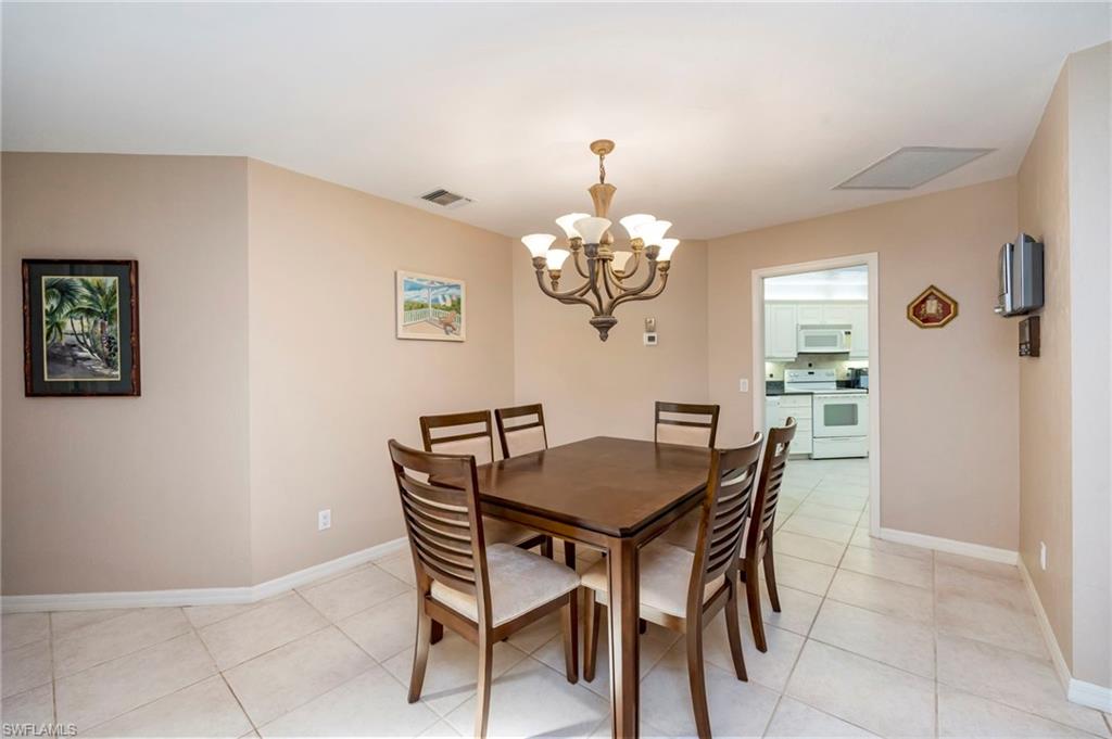 Dining room featuring suspended lighting and light tile patterned floors