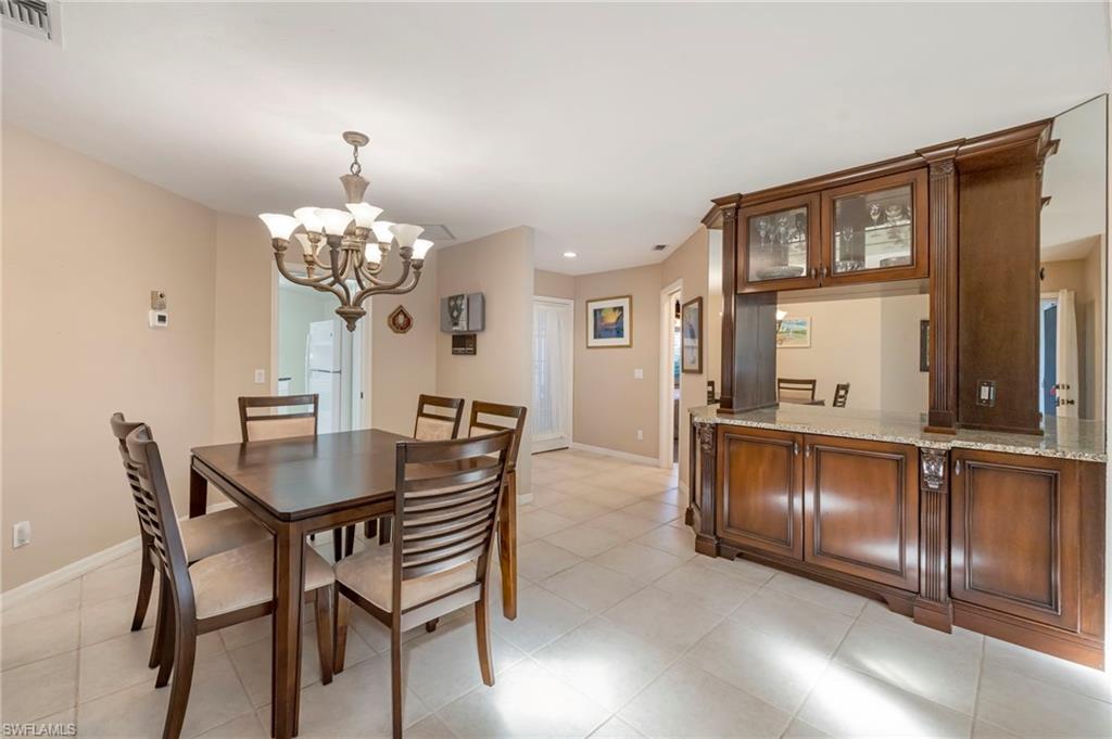 Dining room with a chandelier and baseboards