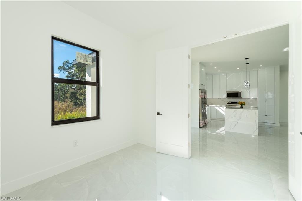 Spare room featuring baseboards