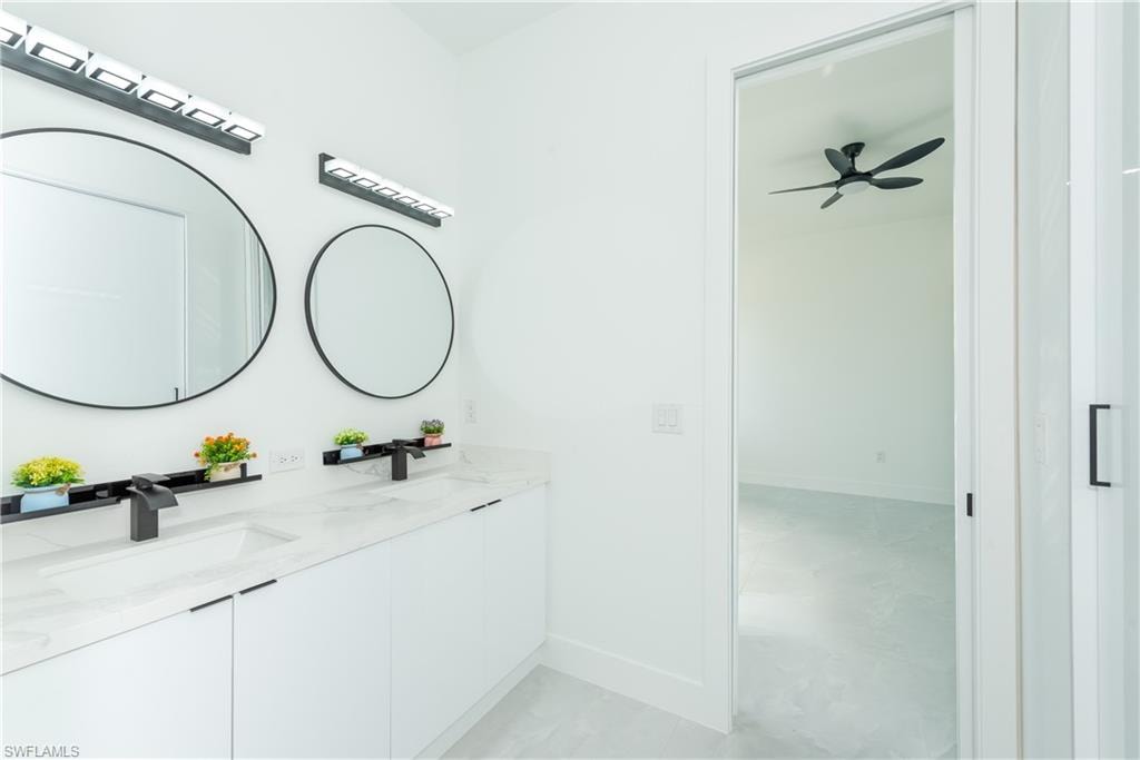 Bathroom featuring double vanity and ceiling fan