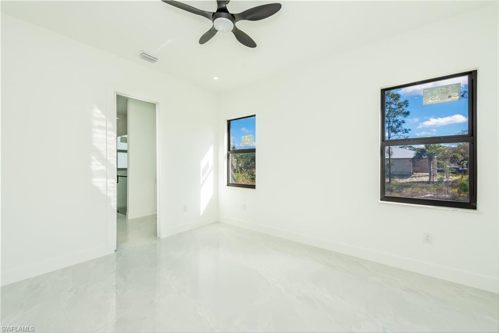 Unfurnished room featuring baseboards and a ceiling fan