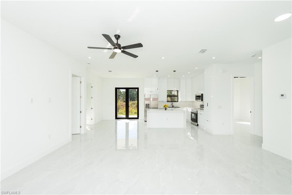 Unfurnished living room with recessed lighting and ceiling fan