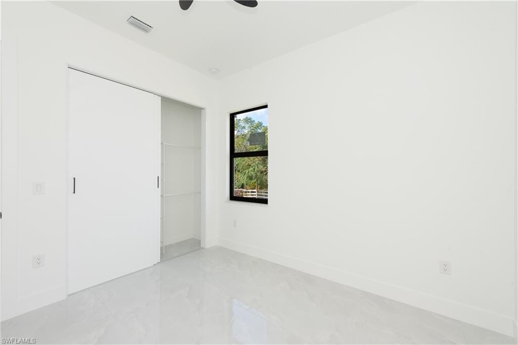 Unfurnished bedroom featuring a closet and ceiling fan