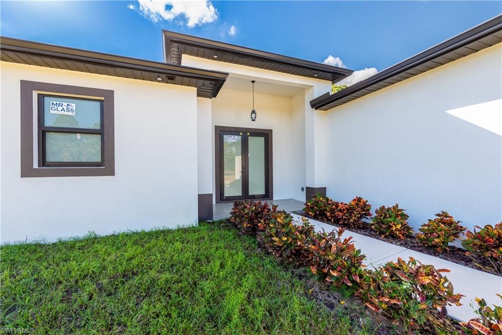 Property entrance with stucco siding