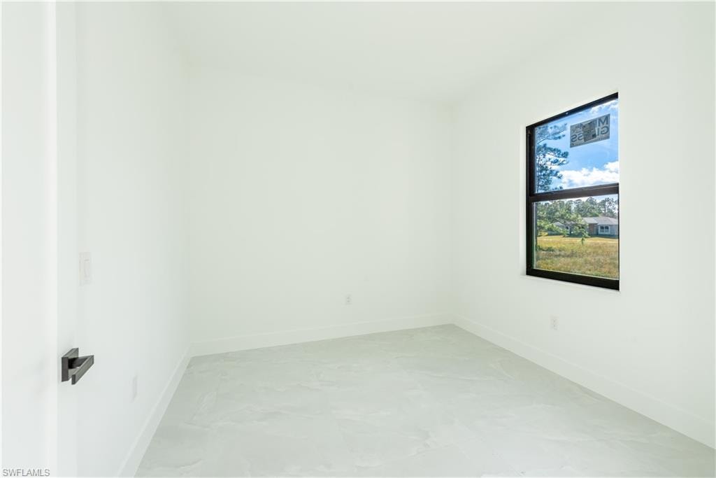 Empty room featuring baseboards