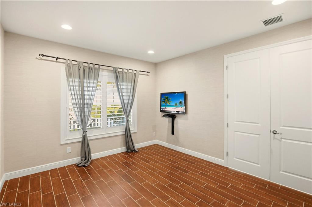 Spare room with wood tiled floors and recessed lighting