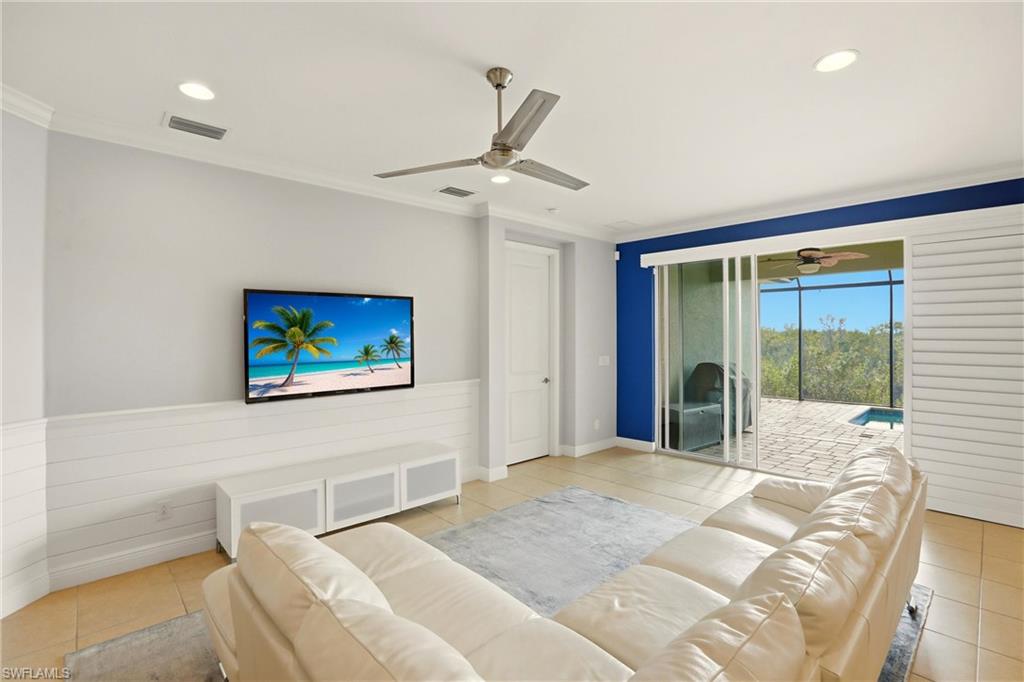 Living room featuring light tile patterned floors, recessed lighting, crown molding, and ceiling fan