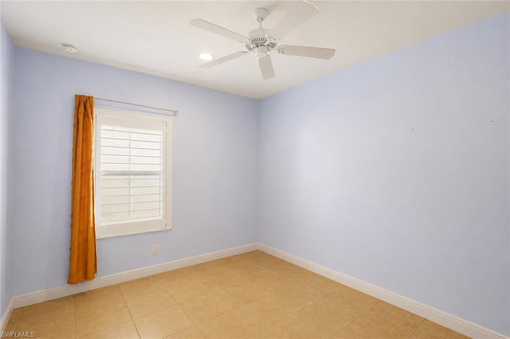 Room featuring tile flooring, a ceiling fan, recessed lighting, and a window with white louvered shutters