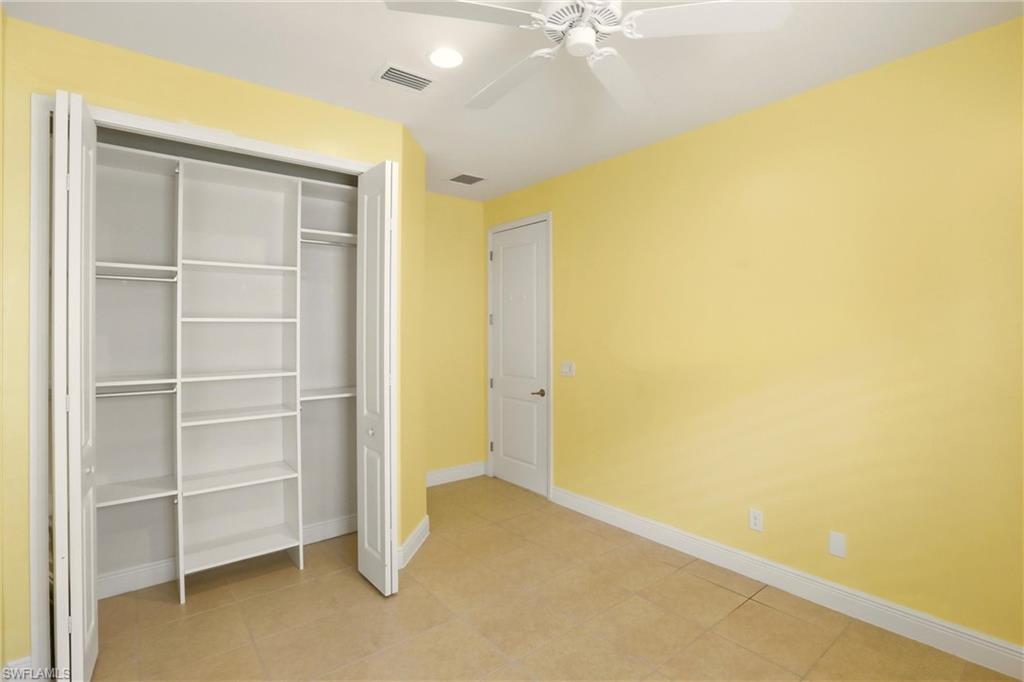 Unfurnished bedroom featuring a closet, ceiling fan, recessed lighting, and light tile patterned flooring