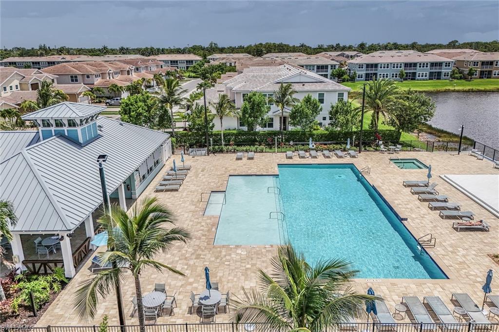 Community pool with a patio area and a water view