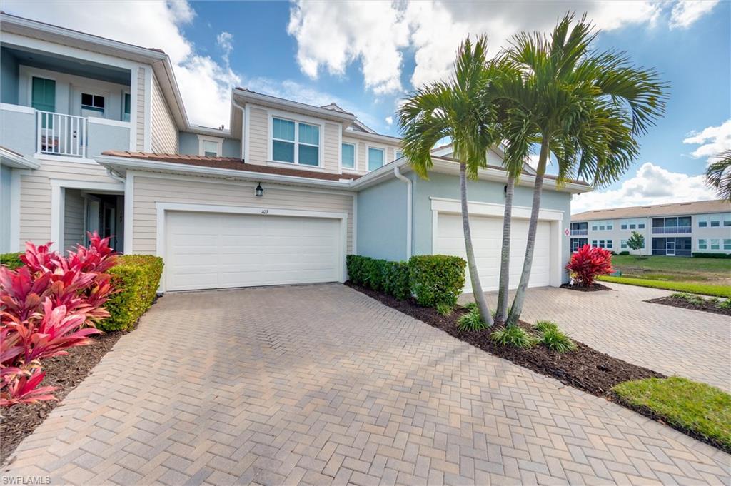 View of front of property with a 2-car garage and driveway