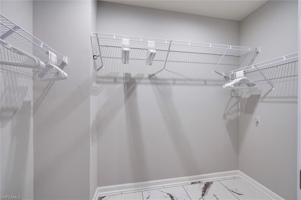 Spacious walk-in closet with tile flooring