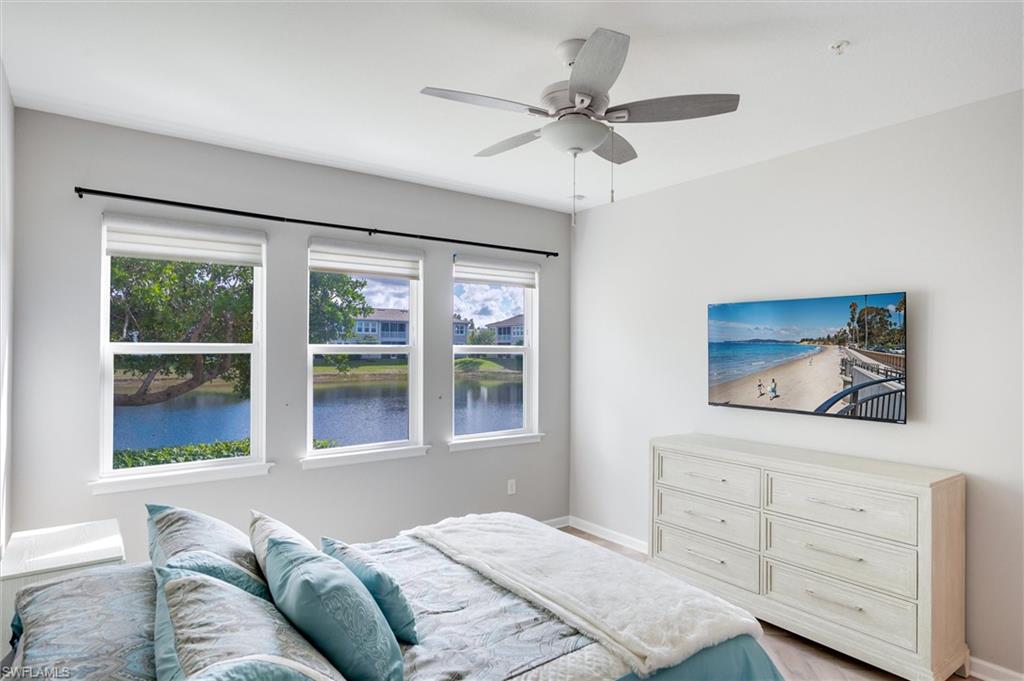 Primary bedroom has a queen size bed, a ceiling fan, TV