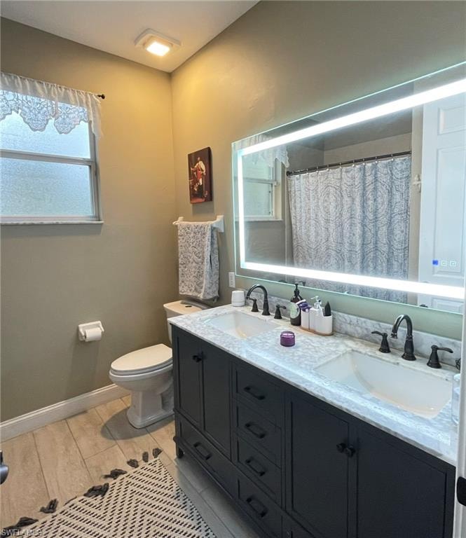 Bathroom with double vanity, a shower with shower curtain, and wood tiled floors