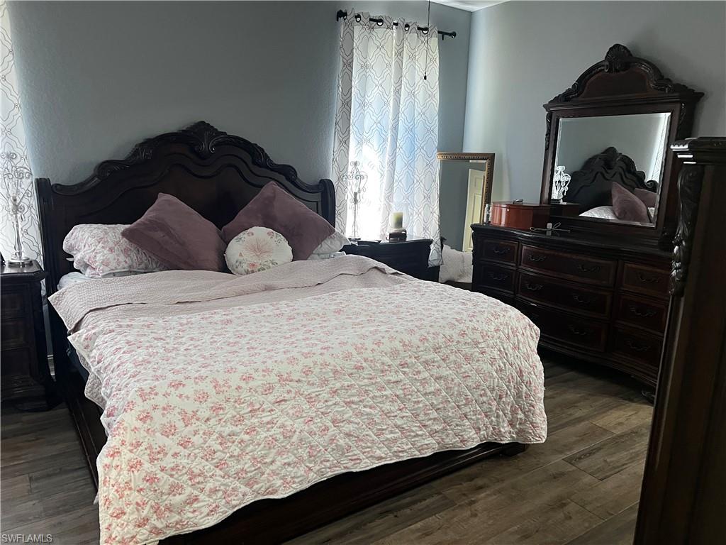 Bedroom with dark wood-style flooring