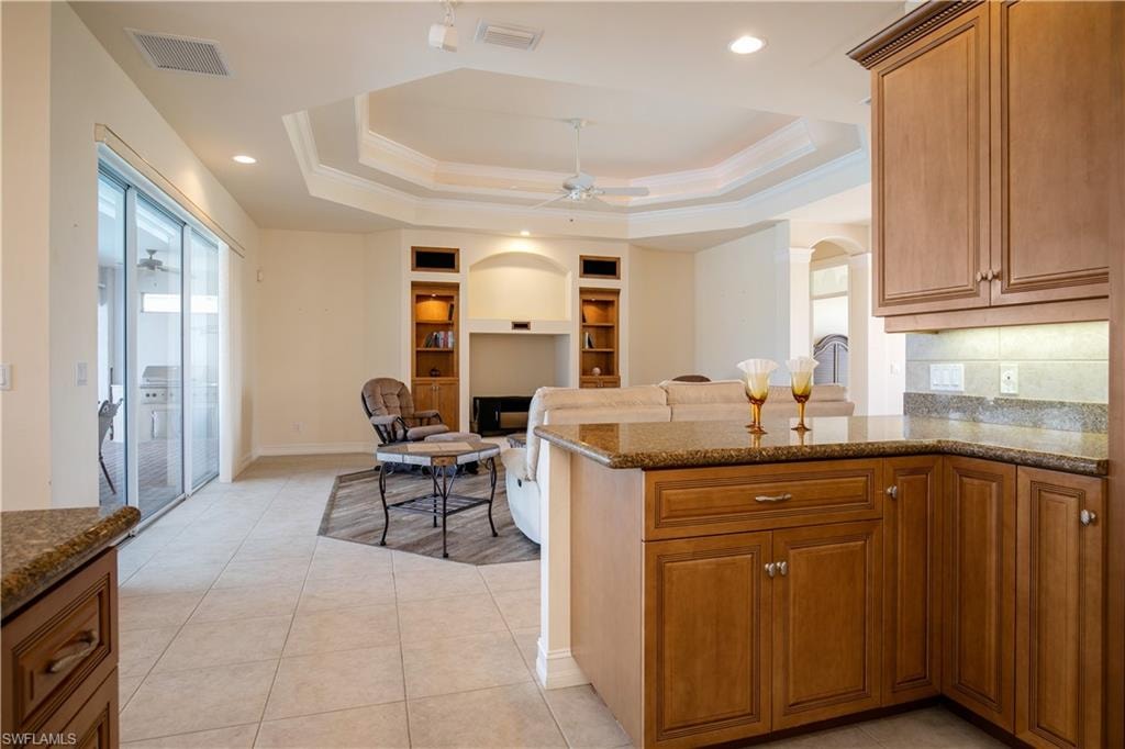 View from Efficient Granite Kitchen to Greatroom, and its Sliders to Lanai Under Truss/Pool Deck