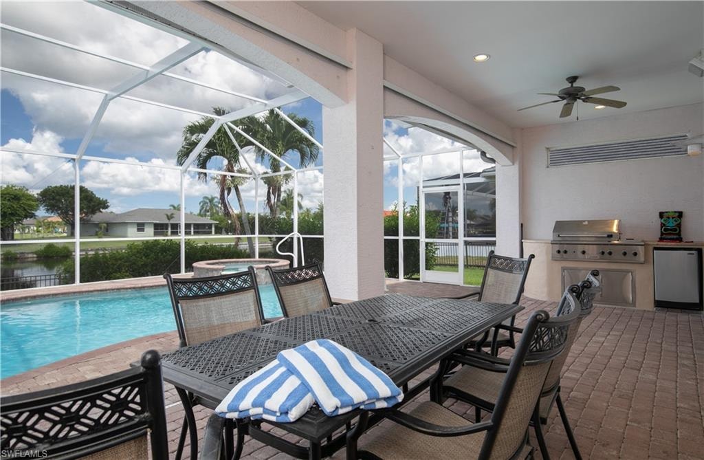 View of Paver Deck Pool/Spa with paver lengthy Lanai Dining and Outdoor Kitchen... all under Truss to enjoy dining under truss view the Cape's outstanding sunsets plus!