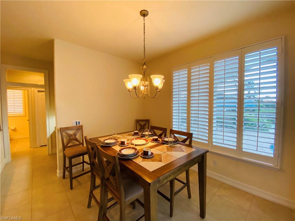 View of Family Dining with Plantation Shuttered Window to Pool Deck