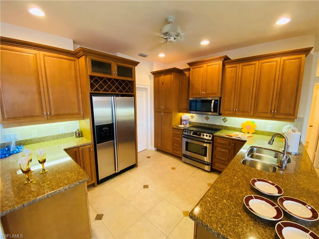 View of Efficient Kitchen with Crown Trim Cabinets, Under Counter Lighting, Granite Counters, Recessed  Ceiling iLighting and Stainless Package