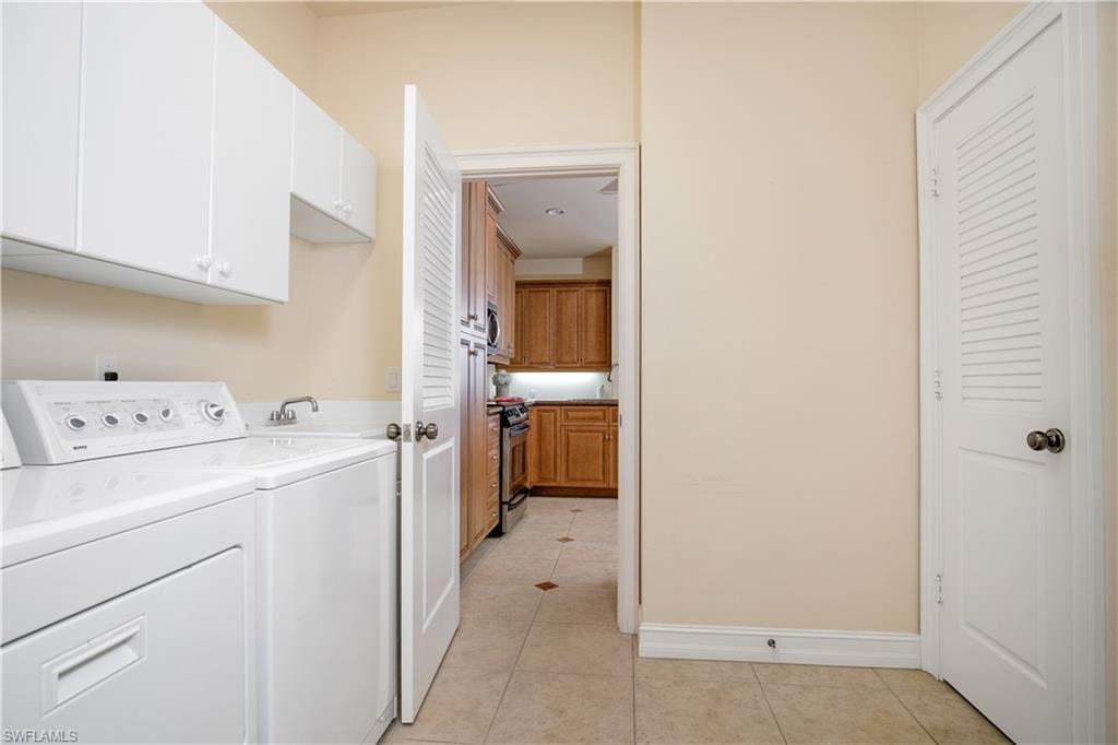 A Utility Room to die for with W/D, Over Appliance Cabinetry, Great Shelved Utility/Pantry Closet and Fold/Store Ironing Board located between Kitchen and Three-Car Garage