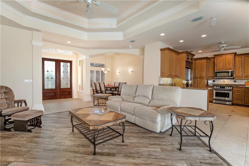 View of Coffered Greatroom/Living Room to Glazed Double Door Foyer Entry, Formal Dining and Granite Kitchen
