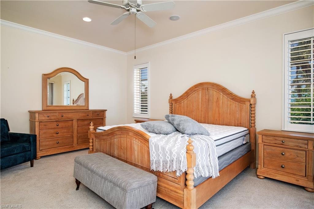 View of sunlit Primary-2/Ensuite with Plantation Shutters, Walk In Closet, Bath w/Walk In Shower, Toilet Closet and Slider to Second Master Deck Seating and Dining