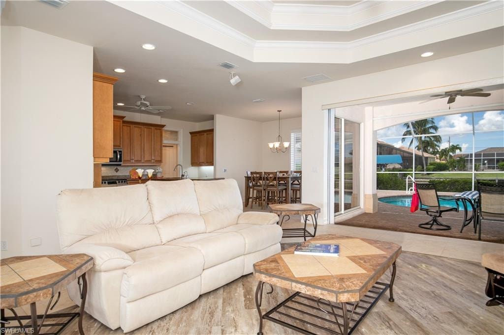 View of Coffered Greatroom/Livingroom to Family Dining, Slider to Lanai Under Truss its Paver Pool and Dining Deck.