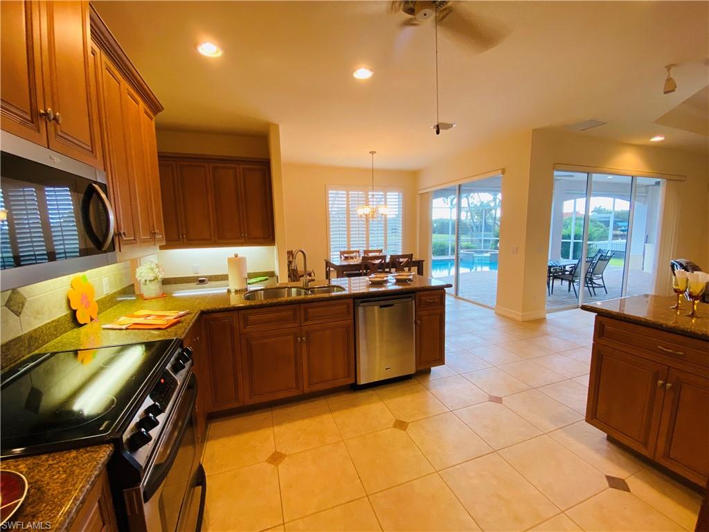 View of Kitchen from Utility Room Doorway to Family Dining and Slider to Lanai-Pool Deck